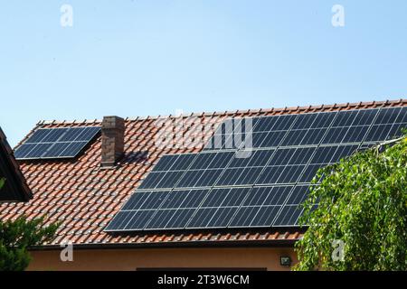 Solar power energy on the roof to a standard house. Solar power panels ,Photovoltaic modules for innovation green energy for life with blue sky backgr Stock Photo
