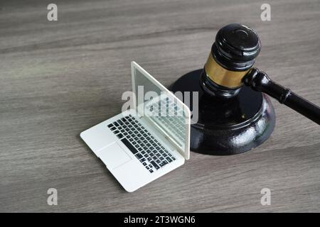 Closeup image of judge gavel and laptop with copy space. Cyber law, computer crime concept. Stock Photo