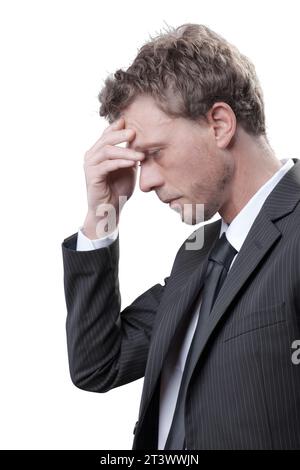 Stressed overworked businessman having a bad headache, he is touching his forehead Stock Photo