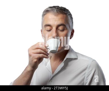 Handsome confident man having a coffee break and drinking espresso Stock Photo