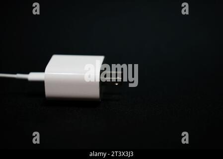 White phone charger with black background (Charger handphone) Stock Photo