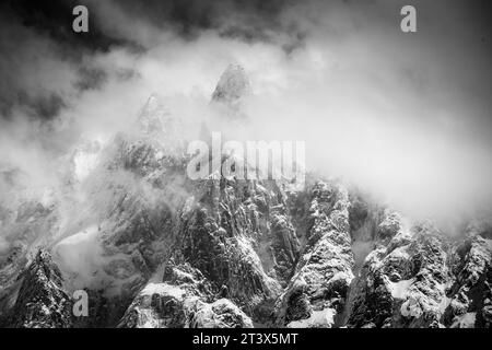 A black and white photo of a jagged rock mountain. Stock Photo