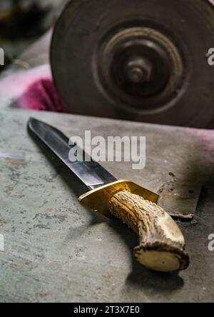 sharpening knife with whetstone in Villajoyosa workshop Stock Photo