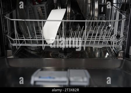 Front view of open automatic stainless steel built-in fully integrated top control dishwasher range machine Stock Photo