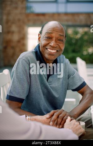 Portrait of happy senior man sitting with woman Stock Photo