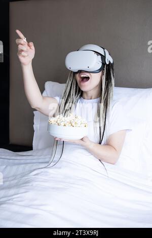 Young women with dreadlocks is using virtual reality helmet Stock Photo