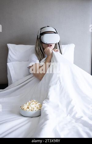 Young women with dreadlocks is using virtual reality helmet Stock Photo