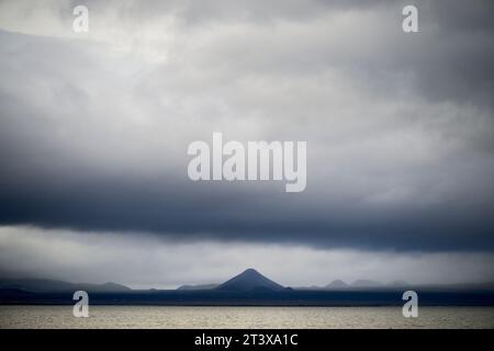 Cloudy dramatic sky over mountains and sea Stock Photo