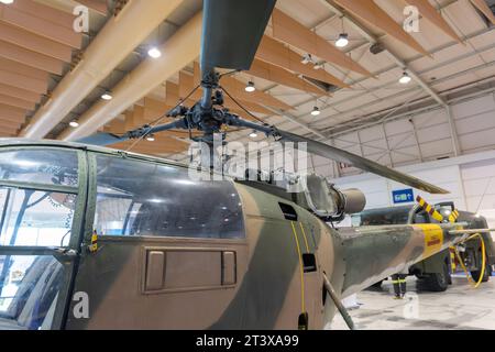 Military helicopter stand inside big hanger Stock Photo - Alamy