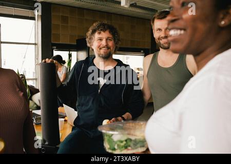 Happy multiracial colleagues talking at office Stock Photo