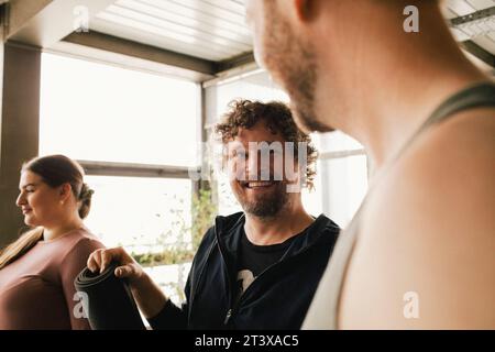 Happy non-binary professional with colleagues in office Stock Photo