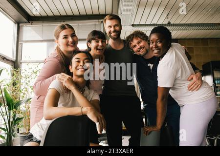 Portrait of happy multiracial colleagues enjoying at office Stock Photo