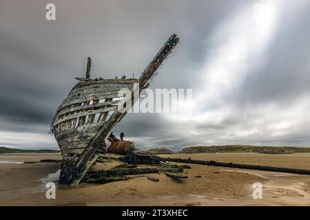 Bád Eddie, also known as Eddie's Boat, is an iconic shipwreck located on Magheraclogher Beach in Gweedore, County Donegal, Ireland. Stock Photo