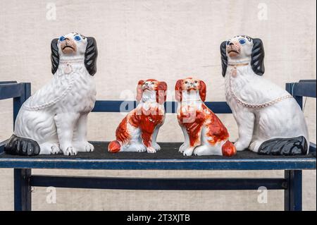 Ornamental Staffordshire china dogs for sale at a country antiques fair, UK Stock Photo