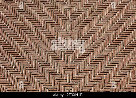 A wall with geometric motifs. Detail of a wall made of brick. Brown wall for background. Stock Photo