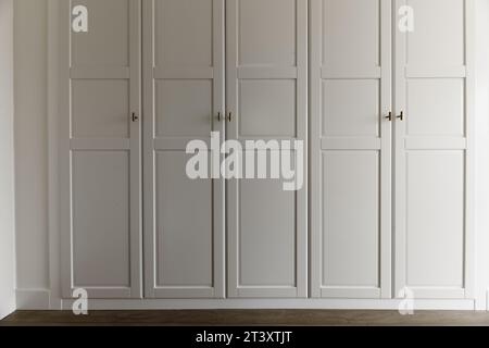 Front of a wardrobe with white wooden doors Stock Photo