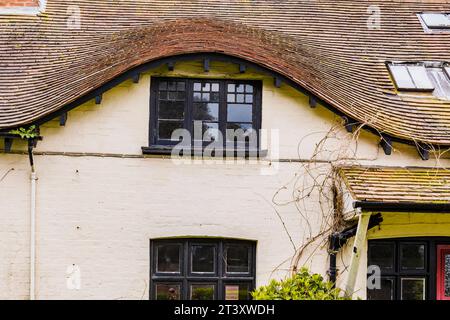 Roof with an eyebrow-shaped dormer at the top of a country house. Milford on Sea, New Forest, Hampshire, England, United Kingdom, Europe Stock Photo