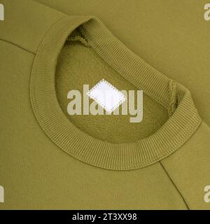 Crew neck of a green sweatshirt clothing tag mockup background close up Stock Photo