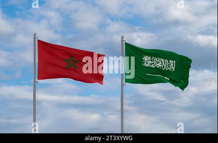 Morocco and Saudi Arabia flags waving together in the wind on blue cloudy sky Stock Photo