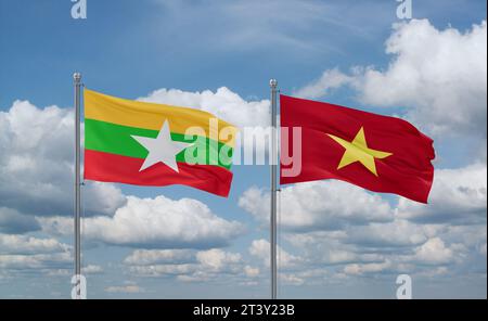 Vietnam and Myanmar flags waving together in the wind on blue cloudy sky Stock Photo