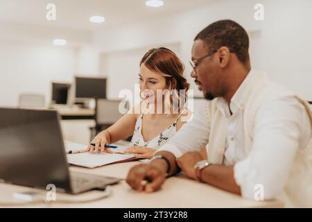 Multiracial Team Collaborating on Strategic Business Plan Stock Photo
