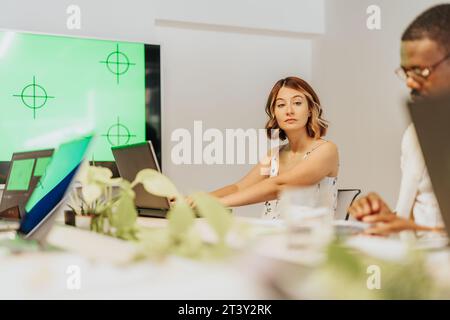 Young, multiracial teammates working together at modern office meeting room, discussing ideas, sharing knowledge for better teamwork results. Stock Photo