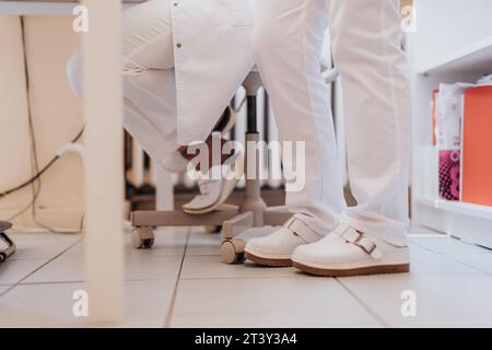 Expert healthcare professional checking vital signs, discussing health issues, and conducting thorough examinations in a serene hospital environment. Stock Photo