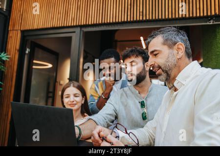 Diverse professionals collaborate in a modern office, brainstorming ideas with teamwork and innovation for business growth. Stock Photo