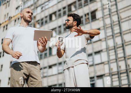 Achieving Urban Design Success: Collaborative Teamwork by Architects and Engineers Discussing Blueprint Outdoors Stock Photo