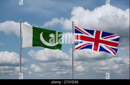 United Kingdom and Pakistan flags waving together in the wind on blue cloudy sky, two country relationship concept Stock Photo