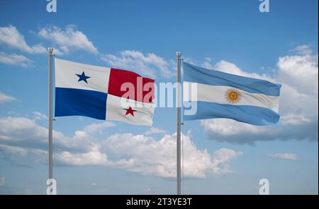 Argentina and Panama flags waving together on blue cloudy sky, two country relationship concept Stock Photo