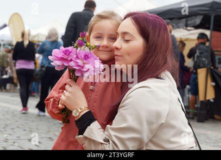 Mother and daughter buying fresh flowers at a farmers market in the center of Prague Stock Photo
