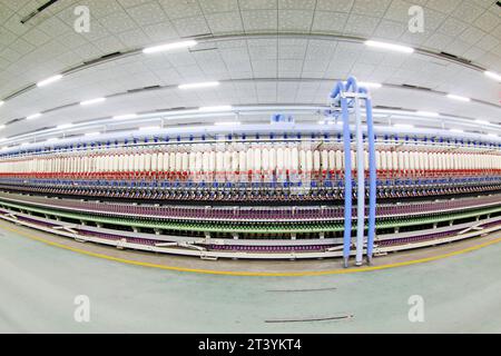 LUANNAN COUNTY - DECEMBER 20: The spinning machinery and spindles in a production workshop, in the ZeAo spinning LTD., on December 20, 2013, Luannan c Stock Photo