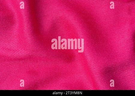 wrinkled pink fabric texture background close-up Stock Photo