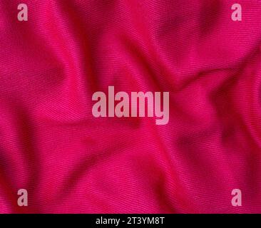 wrinkled pink fabric texture background close-up Stock Photo