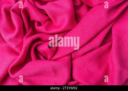 wrinkled pink fabric texture background close-up Stock Photo