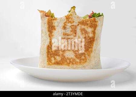 pita envelope with vegetables, pita bread on a white plate Stock Photo