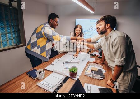 Multiracial architects, engineers, and professionals collaborate in board room. Discussing blueprints, brainstorming ideas for a development project. Stock Photo