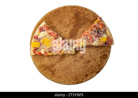 two slices of pizza on a round wooden board on a white background Stock Photo