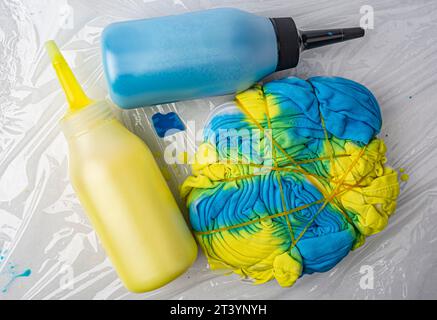 yellow and blue paint bottled in tai dai technique Stock Photo