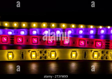 A stack of led lights on coiled flexible lighting strips, various colors Stock Photo
