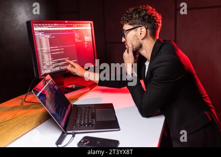 Laptop, screen and business man for coding, software development and programming script in cybersecurity. Night, computer research and programmer or I Stock Photo