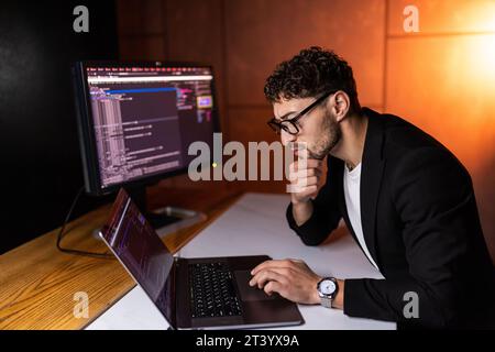 Laptop, screen and business man for coding, software development and programming script in cybersecurity. Night, computer research and programmer or I Stock Photo
