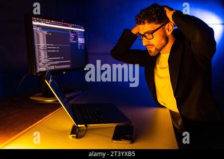 Photo of serious professional programmer look camera improving debugging service experience dark loft space Stock Photo