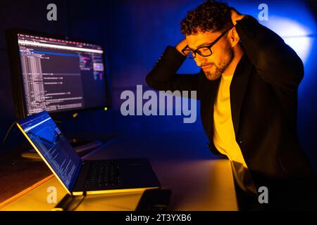 Photo of serious professional programmer look camera improving debugging service experience dark loft space Stock Photo