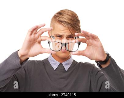 Glasses, vision and portrait of man in a studio with confused, doubt or squinting facial expression. Optometry, health and young male person with Stock Photo