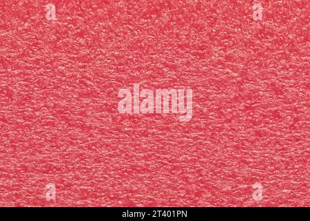 Melon pink expanded polyethylene foam sample background. EPE beads packing material with macro details, textures and one solid color. Stock Photo
