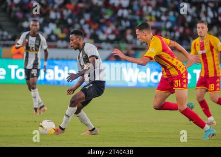 DAR ES SALAAM, TUNISIA – OCTOBER 22:    PHILLIPPES BENI KINZUMBI of Mazembe and Esperance defenders during the African Football League match between T Stock Photo