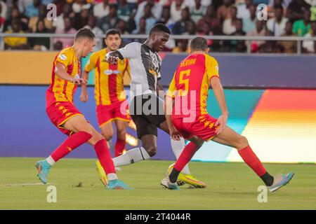 DAR ES SALAAM, TUNISIA – OCTOBER 22:    OUSSEINI SOUMAILA BADAMASSI of Mazembe and Esperance defenders during the African Football League match betwee Stock Photo
