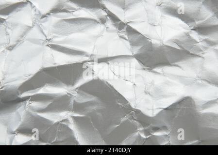 Texture of crumpled silver paper. Background made of crumpled paper with folds Stock Photo